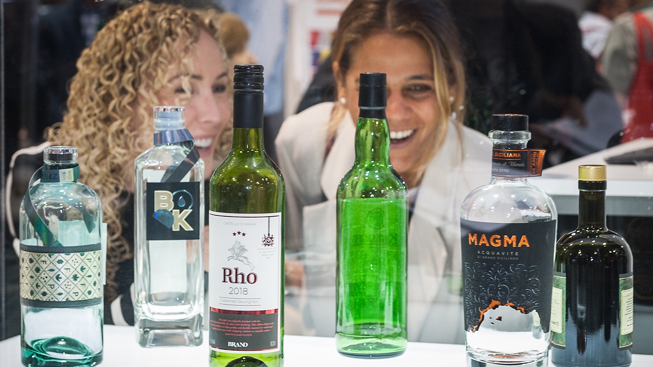 Two women look at wine bottle labels