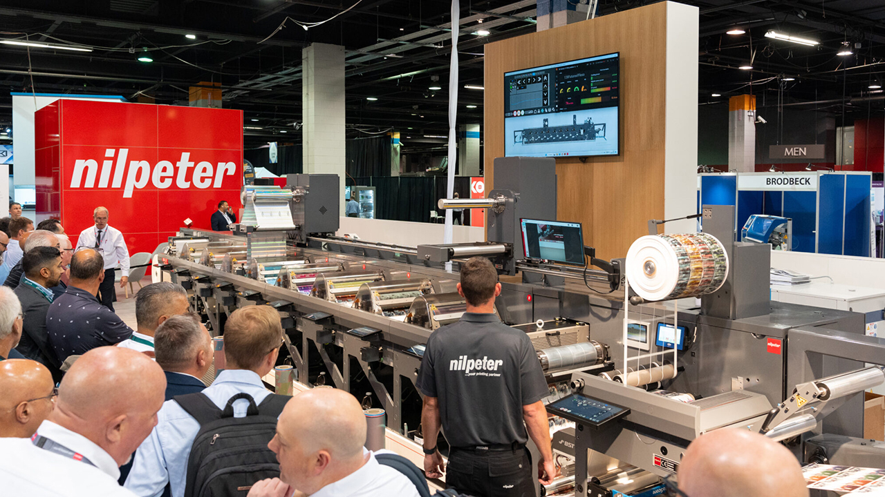 Nilpeter press at a trade show booth