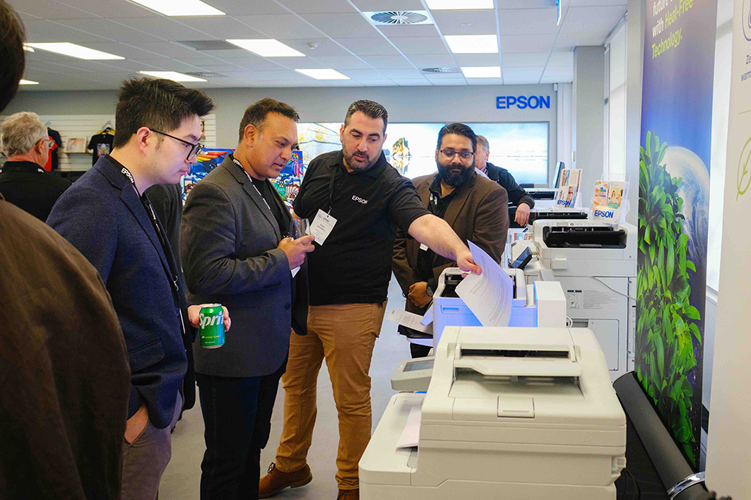 Attendees look at an Epson machine