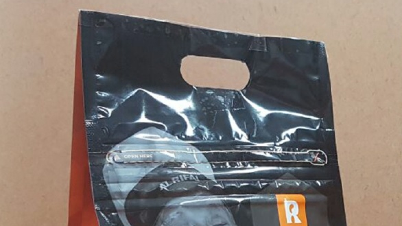 An integrated D-punch handle and press-to-close zipper feature in the new pouch structure An integrated D-punch handle and press-to-close zipper feature in the new pouch structure