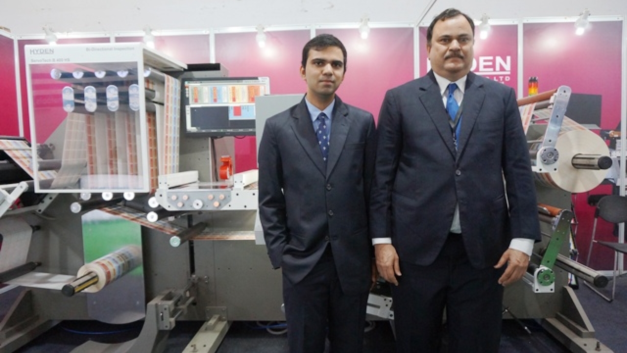 Promod Jayakar, managing director, Hyden Packaging, with his son Aditya Jayakar, CAT Systems Engineer, at the launch of Hyden ServoTech B400HS bi-directional slitting inspection machine on day one of Labelexpo India 2016