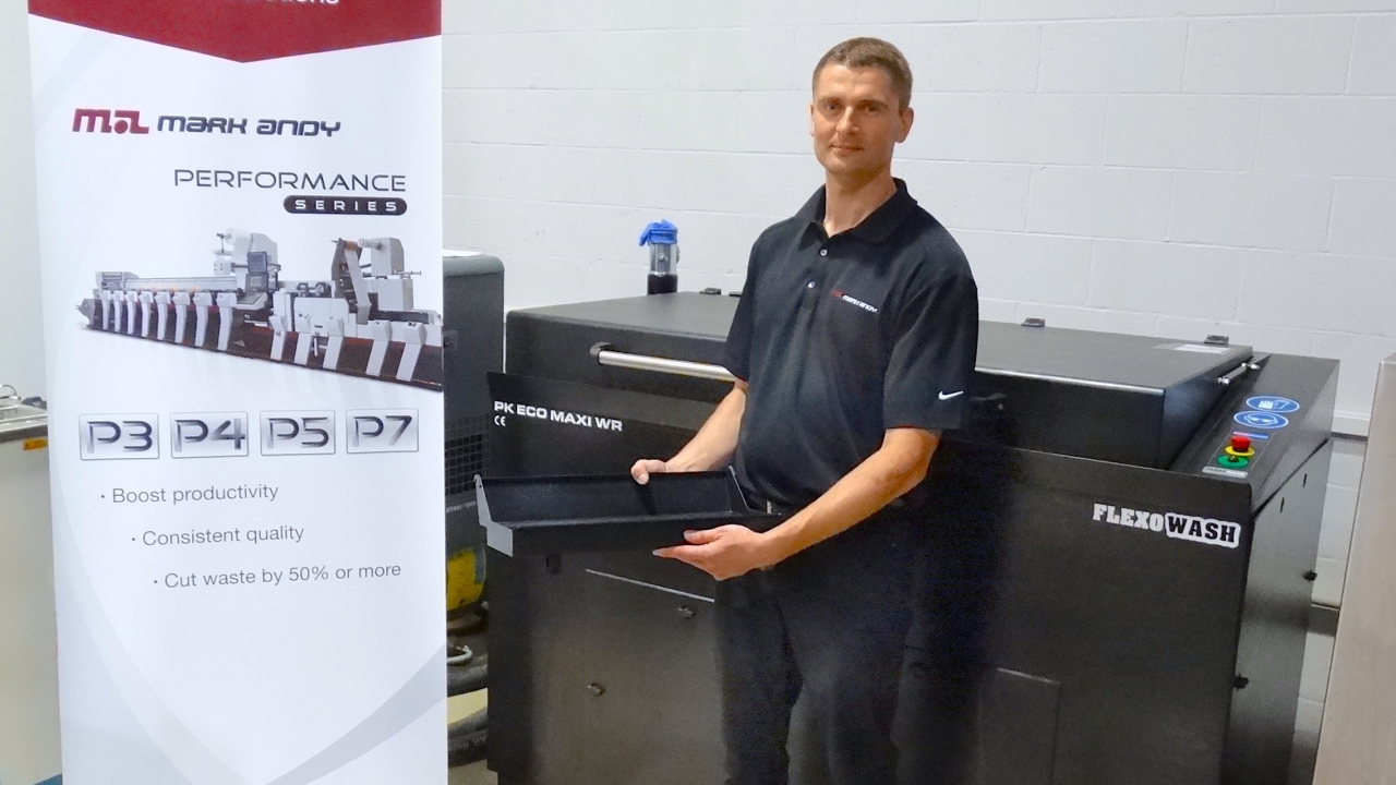 Mark Andy print Instructor Michal Mockrzycki with the company’s new Flexo Wash machine in the Warsaw demo showroom and technical center