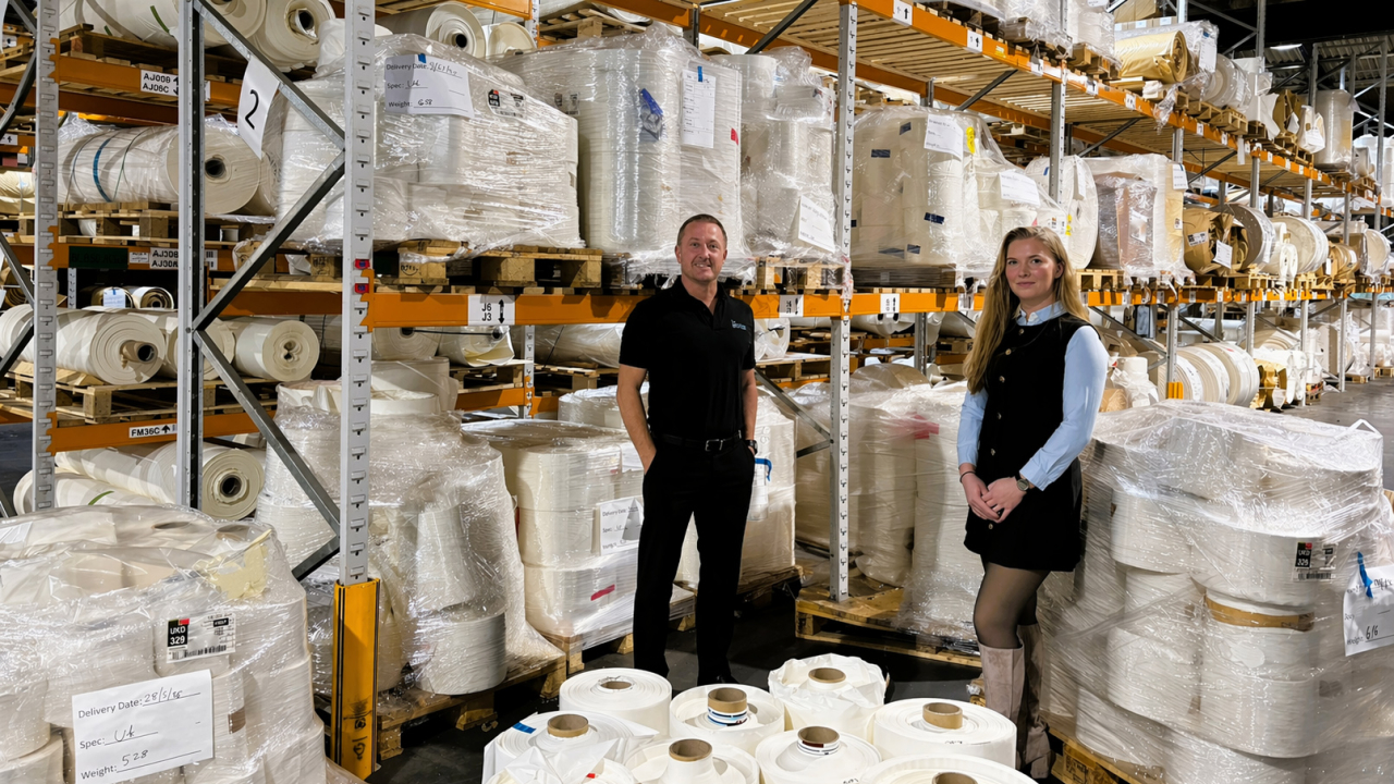 Mark Thompson and Marci Clarke surrounded with rolls of material