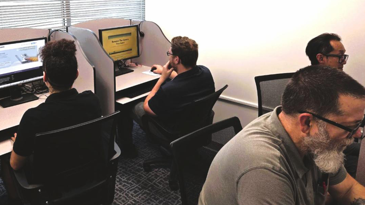 People participate in an online training program at computers