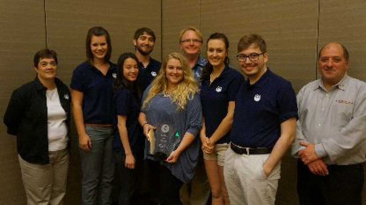 The team members from Clemson University accept the Overall Winners Award from Bettylyn Krafft of Phoenix Challenge Foundation and Joe Tuccitto of the Flexographic Technical Association The team members from Clemson University accept the Overall Winners Award from Bettylyn Krafft of Phoenix Challenge Foundation and Joe Tuccitto of the Flexographic Technical Association