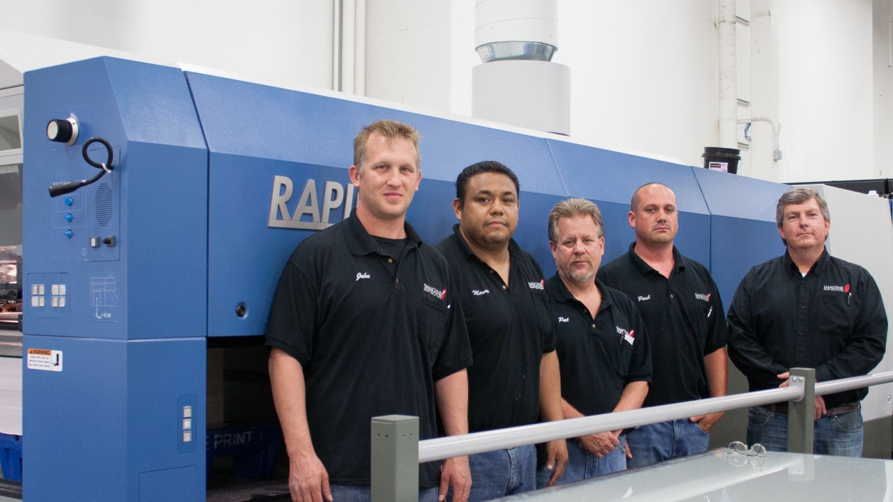 Imagine! Print Solution employees surround the new KBA Rapida 105 41in 6-color press with UV; pictured (from left) John Mack Jr, director of pressroom training and development; Mauro Gonzalez Pereguera, press feeder; Pat Freundschuh, pressroom supervisor ; Paul Rulli, press operator; and Mike McLaughlin, vice-president of manufacturing Imagine! Print Solution employees surround the new KBA Rapida 105 41in 6-color press with UV; pictured (from left) John Mack Jr, director of pressroom training and development; Mauro Gonzalez Pereguera, press feeder; Pat Freundschuh, pressroom supervisor ; Paul Rulli, press operator; and Mike McLaughlin, vice-president of manufacturing
