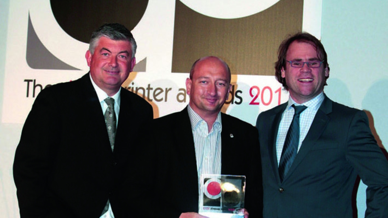 Pictured: Adrian Steele (center) collecting the Digital Printer Award 2013 for Mercian Labels from John Parrot MBE (left) and Filip Weymans of Xeikon (right)