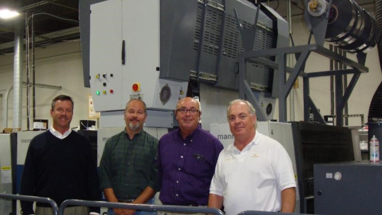 Packaging Graphics’ John Gaffney, Mario Lemos, and Kevin Tranor join Eagle Systems’ president and chief executive officer Mike King to celebrate the install of their new Eco-Eagle cold foil system.