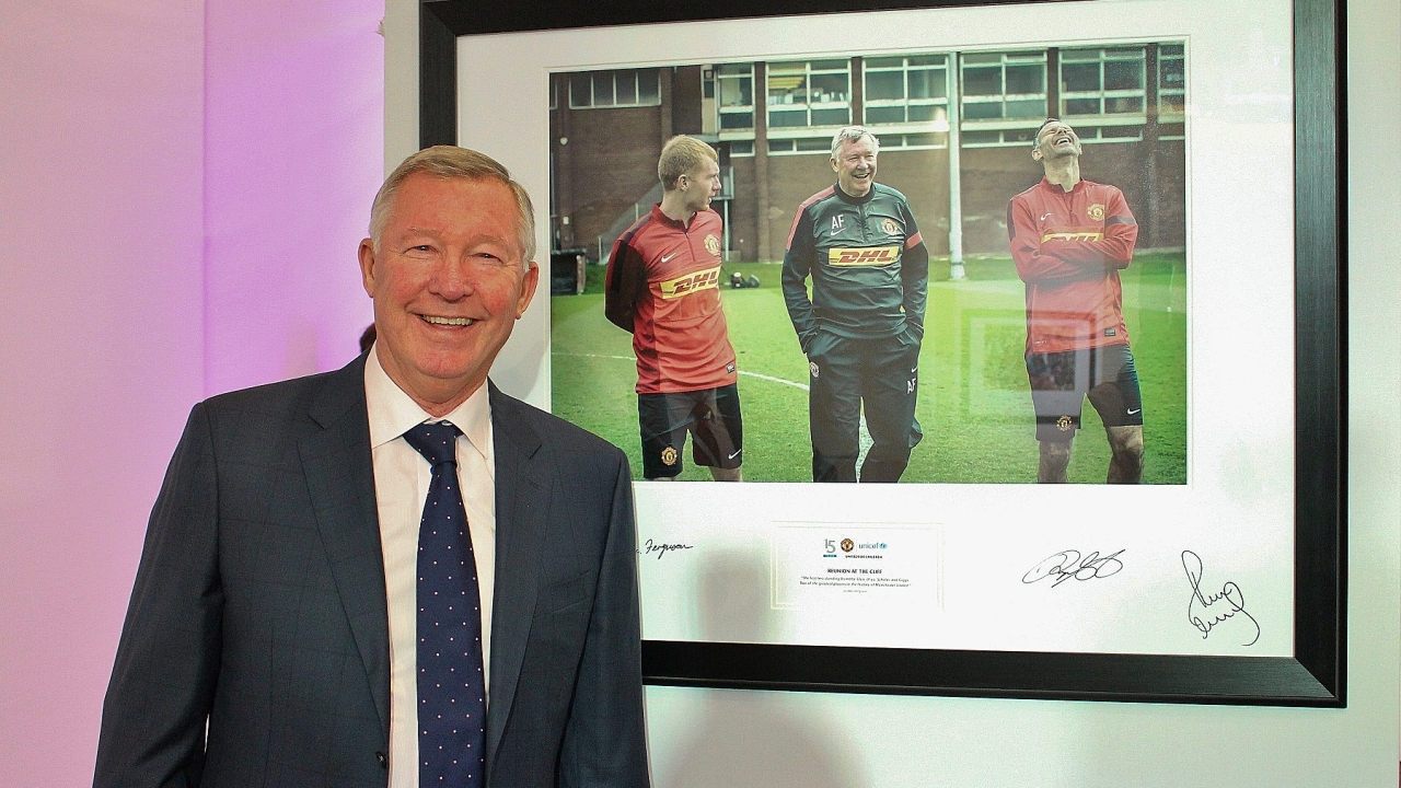 Sir Alex Ferguson with some of the images printed by Epson that he has chosen to raise money for United for UNICEF