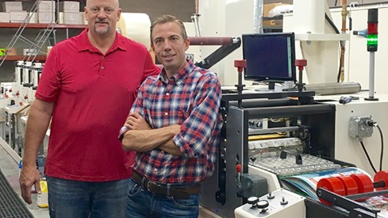 Pictured: FlexoOne CEO Matt Sherry and COO Scott Opfar alongside one of the company’s new Nilpeter FB servo presses