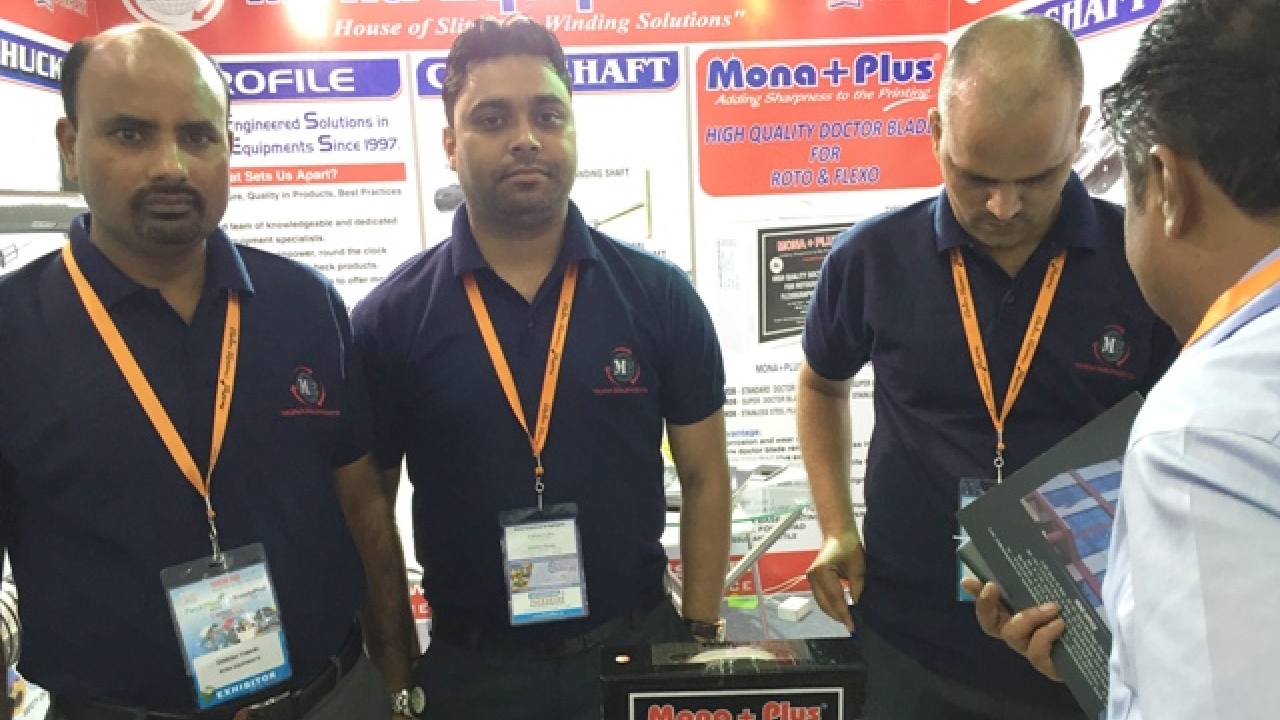 Pawan Kumar Singh (center) at his company's stand during a trade show 