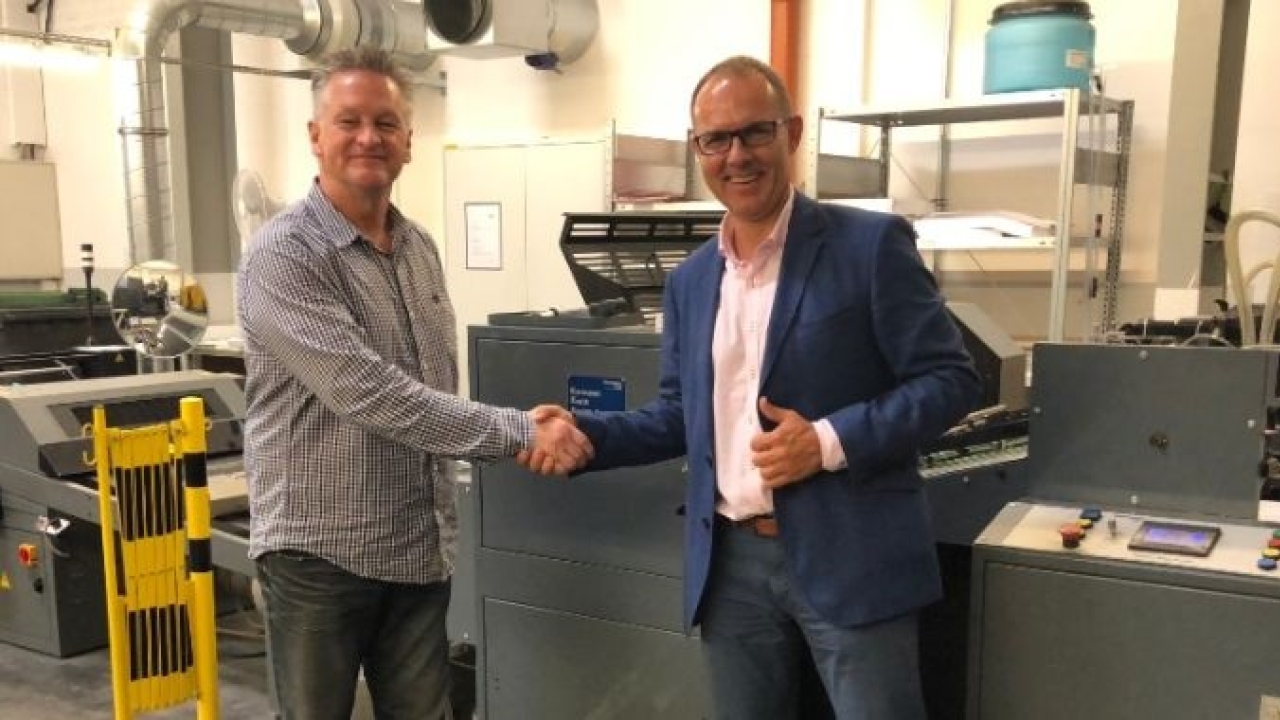 Thomas Hayes (left), Kompac president, and Krzysztof Pisera (right), business development director, Scorpio, standing with a Kwik Finish 32 UV and aqueous coating system.