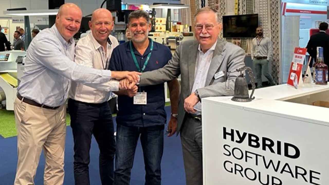 (L-R) Olivier Moeyersoms, Hybrid   Software regional sales manager France, Pascal Pernot, Hybrid Software sales manager France, Christophe Seguin, managing director of ELC Etiquettes, and Guido Van der Schueren, chairman of the Board at Hybrid Software Group ring the bell to celebrate a new order