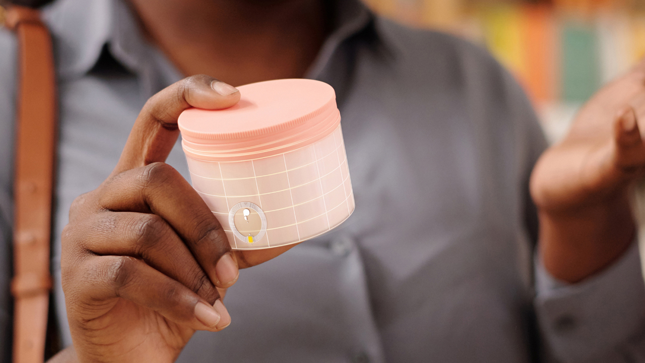A person holds an item with the NFC Connect chip