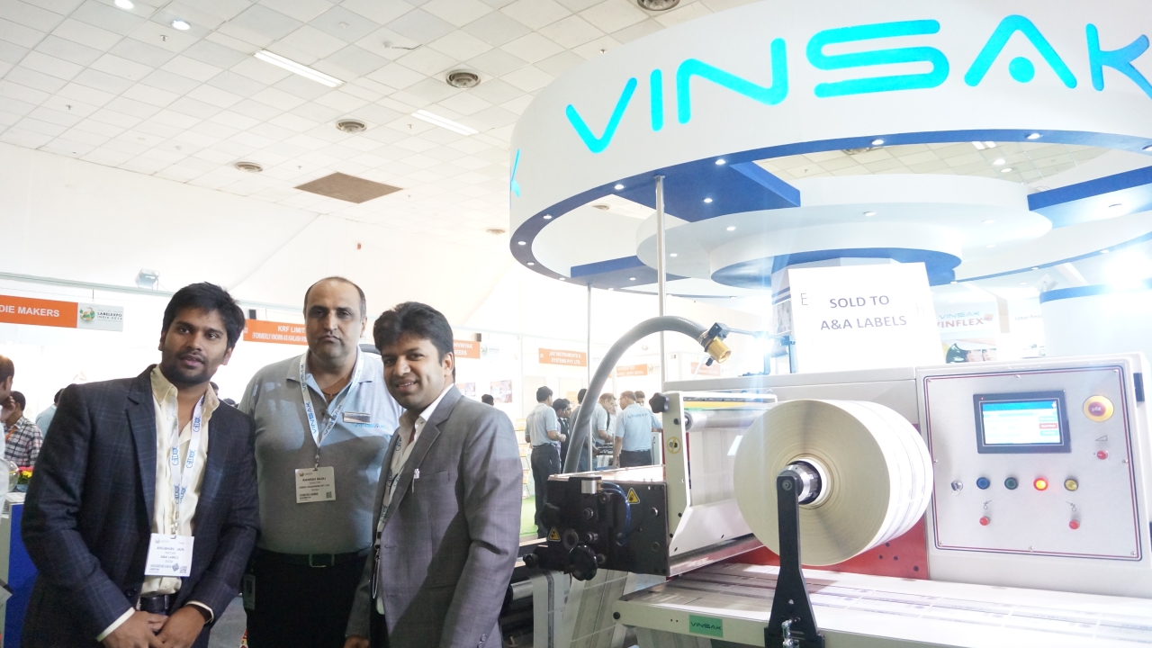 Saurabh Jain and Anubhav Jain, directors at A&A Labels and Ranesh Bajaj, director, Vinsak with the new 17-inch wide Vinsak slitter rewinder at Labelexpo India 2014
