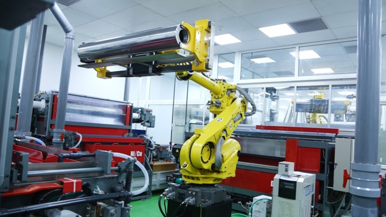 Robotic arm feeding the steel base shell for nickle copper electroplating in plant section B at Uflex Noida, India