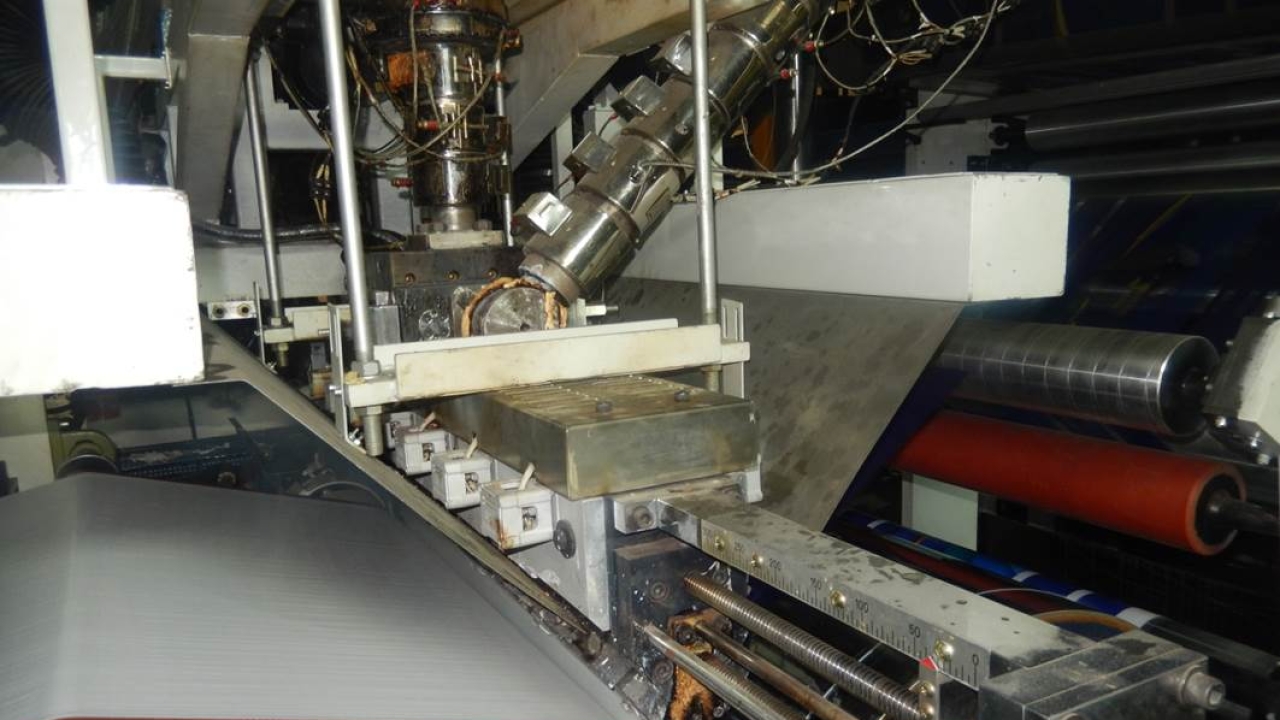 T-die section of the extrusion lamination machine EL-1300 manufactured by Uflex T-die section of the extrusion lamination machine EL-1300 manufactured by Uflex