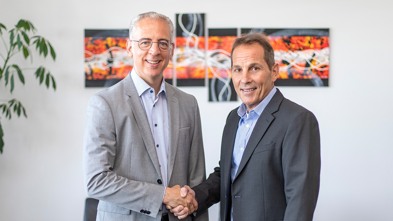 Roland Schreiner and Ken Forlenza shake hands