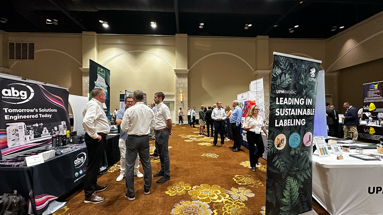 Attendees network at booths at the TLMI Annual Meeting