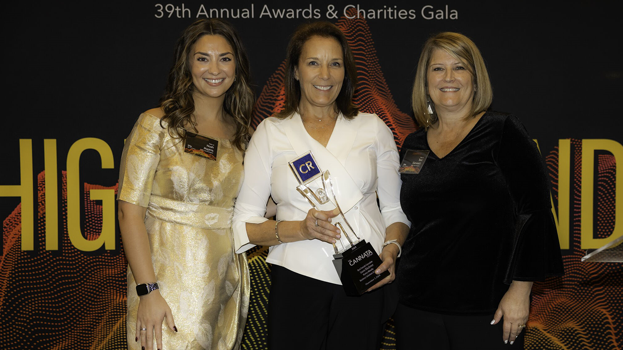 Noah Maphis, Laura Blackmer holding an award and Toni Gorveatt