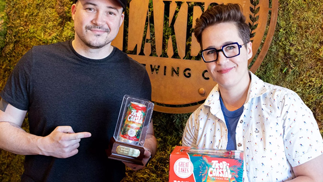Great Lakes Brewing Company’s creative manager Jameson Campbell and brand marketing manager Marissa DeSantis show off 2022 Colored by INX Can Design Contest trophy with winning craft beer entry for TropiCoastal Tropical IPA Great Lakes Brewing Company’s creative manager Jameson Campbell and brand marketing manager Marissa DeSantis show off 2022 Colored by INX Can Design Contest trophy with winning craft beer entry for TropiCoastal Tropical IPA