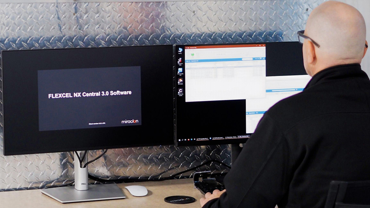 A man uses the Flexcel NX Central Software 3.0 on a computer