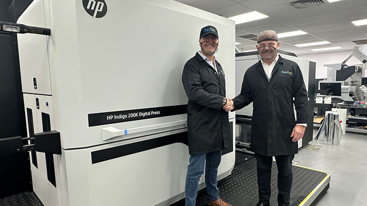 Steve Baker shakes hands with Darren Godfrey in front of new press