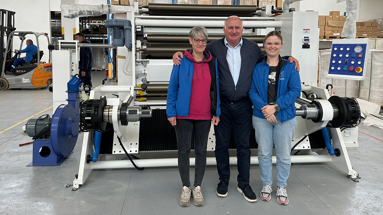 The company CEO, Tibor Kovács, with team members and the recently installed slitting machine.  