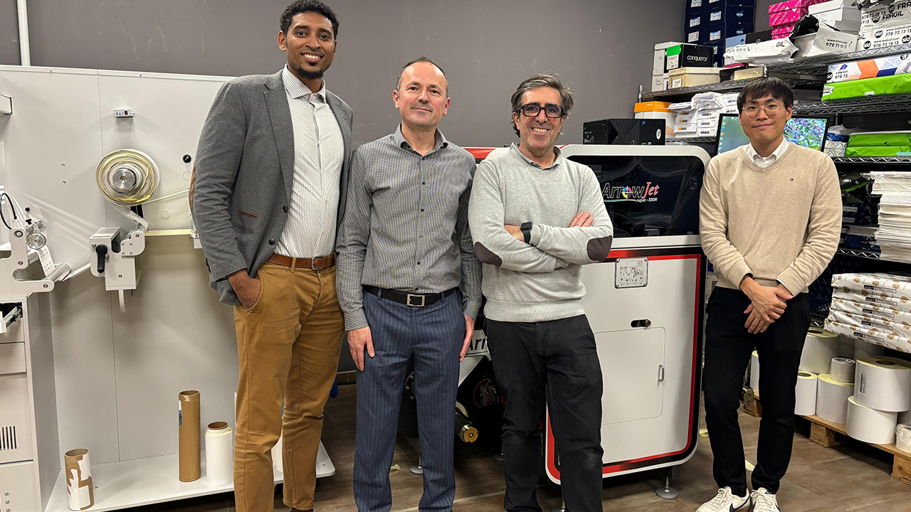 Four men stand in front of a ArrowJet Aqua 330R machine