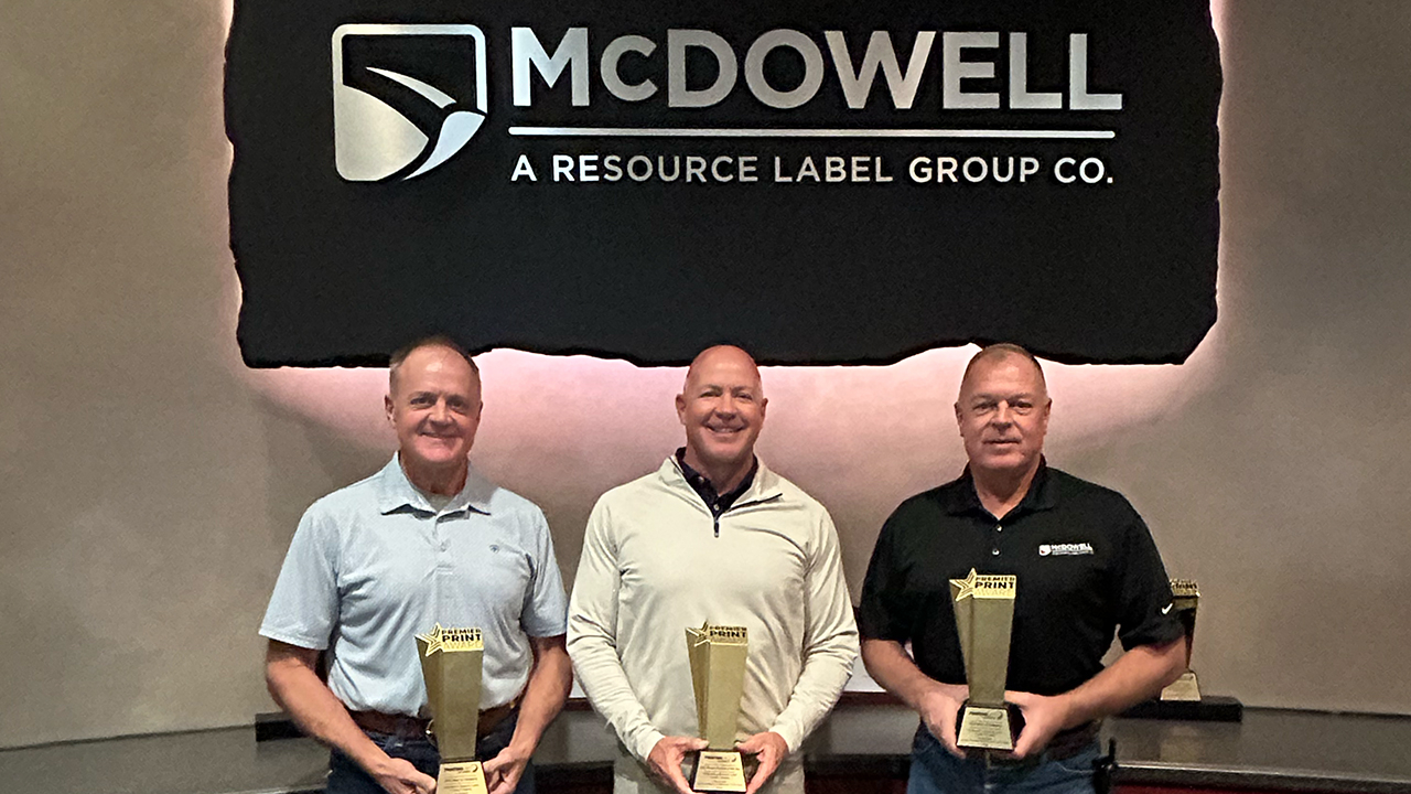 Jeff McDowell, John McDowell and David Wayne McDowell holding awards