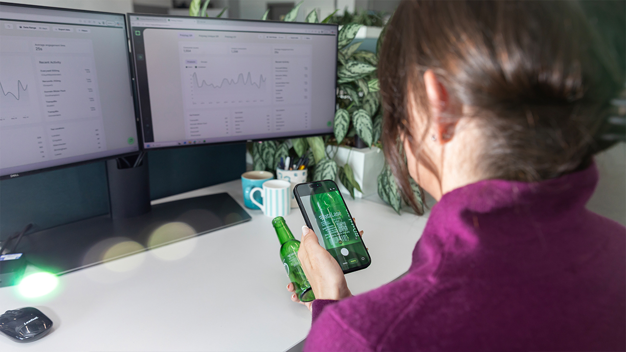 A woman scans a QR code on a bottle