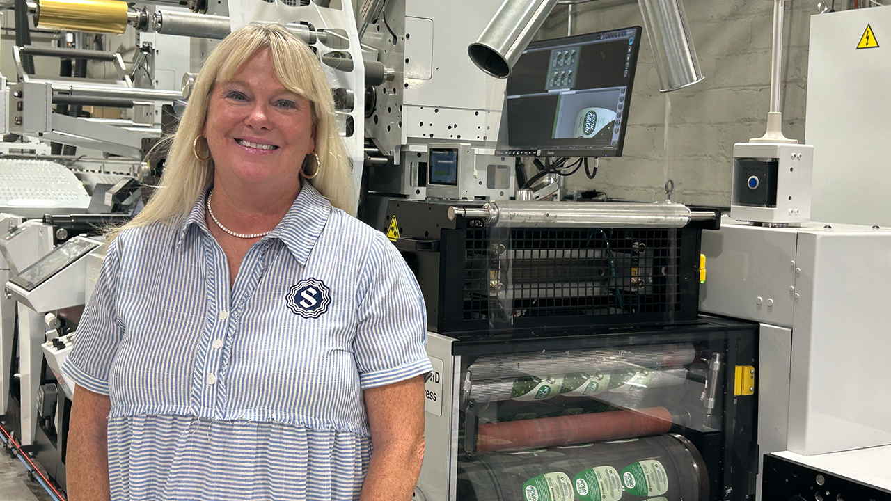 Tara Halpin in front of the Mark Andy hybrid press