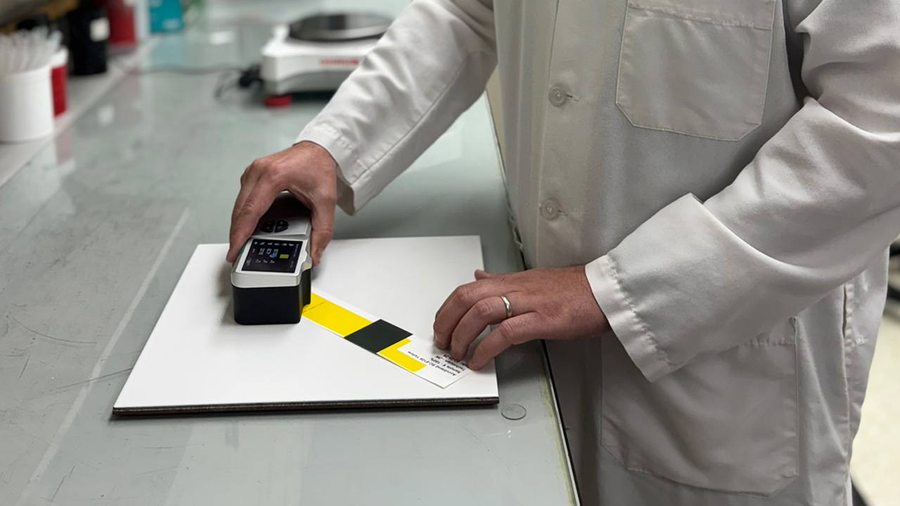 A man uses a color measurement tool