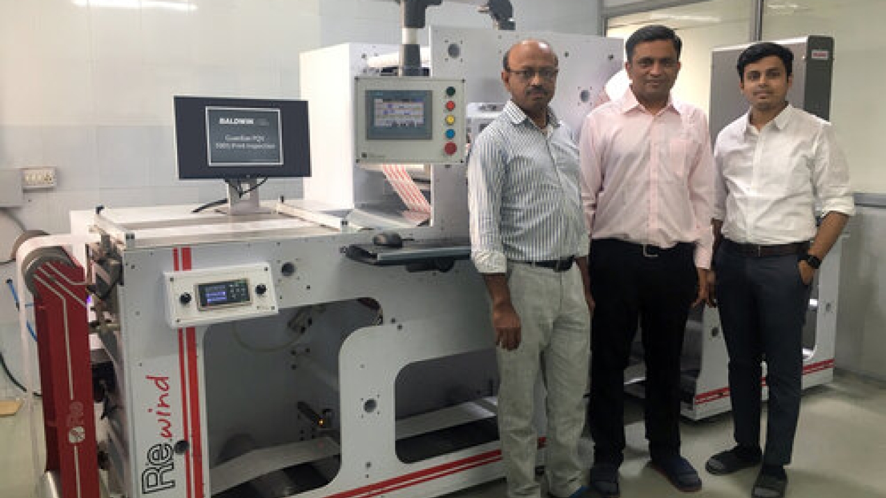 Bhavya Shah (left) and Manish Patel (right) of Shreedhar Labels with Amit Desai of Baldwin Vision Systems, and the Guardian PQV 100 percent inspection system installed on their Re brand rewinder. Bhavya Shah (left) and Manish Patel (right) of Shreedhar Labels with Amit Desai of Baldwin Vision Systems, and the Guardian PQV 100 percent inspection system installed on their Re brand rewinder.