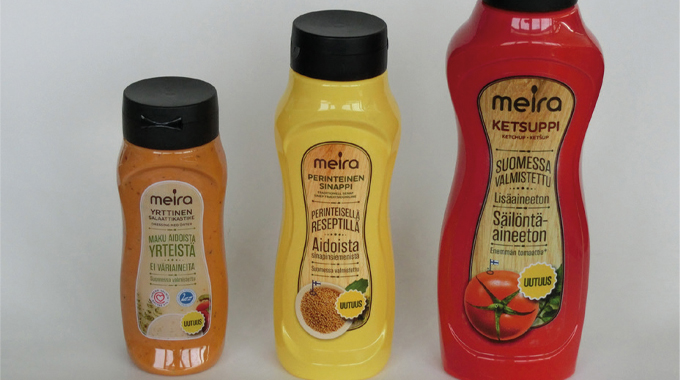 Figure 1.5 - Labels for Finnish food producer Meira are centerd exactly in a molded container recess in the tapered bottles Figure 1.5 - Labels for Finnish food producer Meira are centerd exactly in a molded container recess