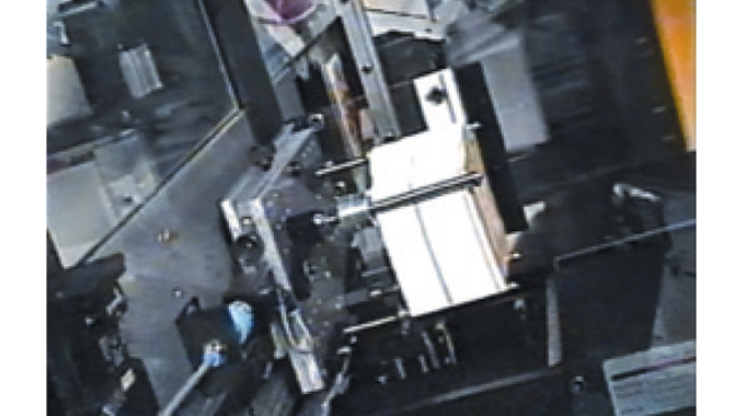 Figure 5.3 Blumer Strip cutting and ram punching unit profile cutting a wet-glue label