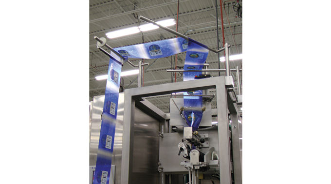 Figure 7.15 Shrink sleeve is guided and registered onto the shrink sleeve applicator. Source- Accraply Figure 7.15 Shrink sleeve is guided and registered onto the shrink sleeve applicator. Source- Accrap