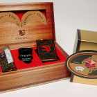 When opened, the wood effect box contains several Cenveo branded items, such as beverage coasters, a deck of playing cards, a carton with five dice and a shot glass
