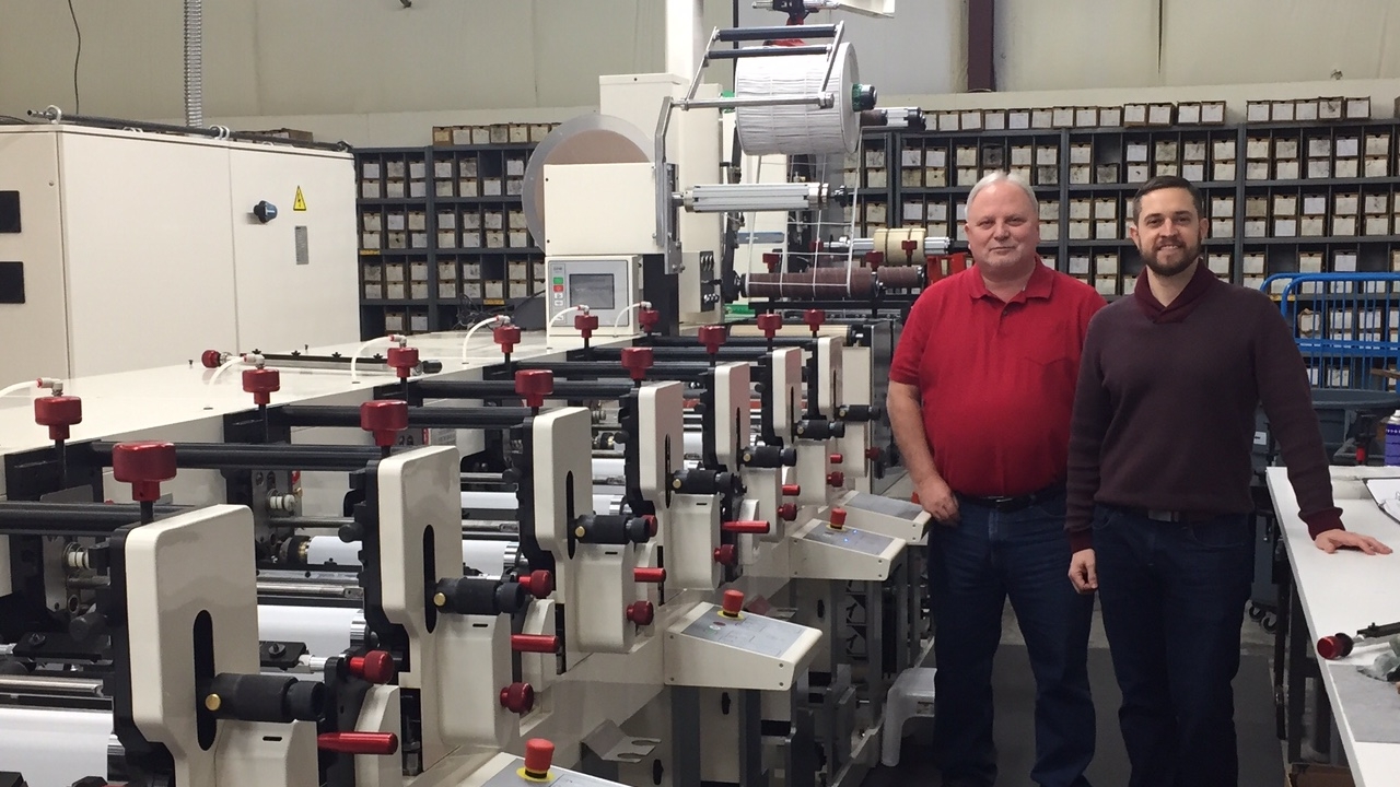 Liberty Marking Systems vice president Brian Beam (right) and production manager Stan Berger (left), with the new Nilpeter FB-3300S flexo press