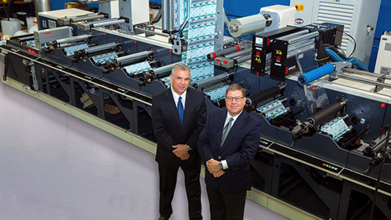 Control Group owners Bill Cheringal (left) and Jeff Levine (right) with the company’s latest Nilpeter press