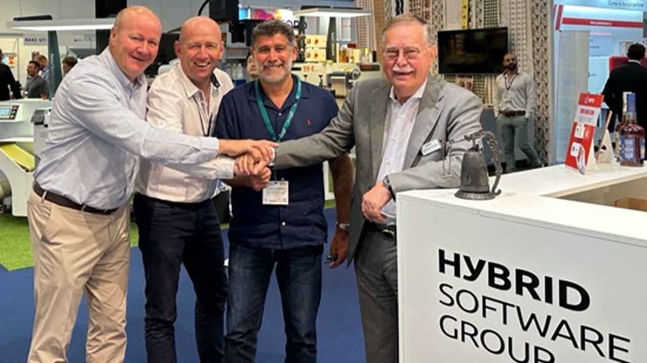(L-R) Olivier Moeyersoms, Hybrid Software regional sales manager France, Pascal Pernot, Hybrid Software sales manager France, Christophe Seguin, managing director of ELC Etiquettes, and Guido Van der Schueren, chairman of the Board at Hybrid Software Group ring the bell to celebrate a new order