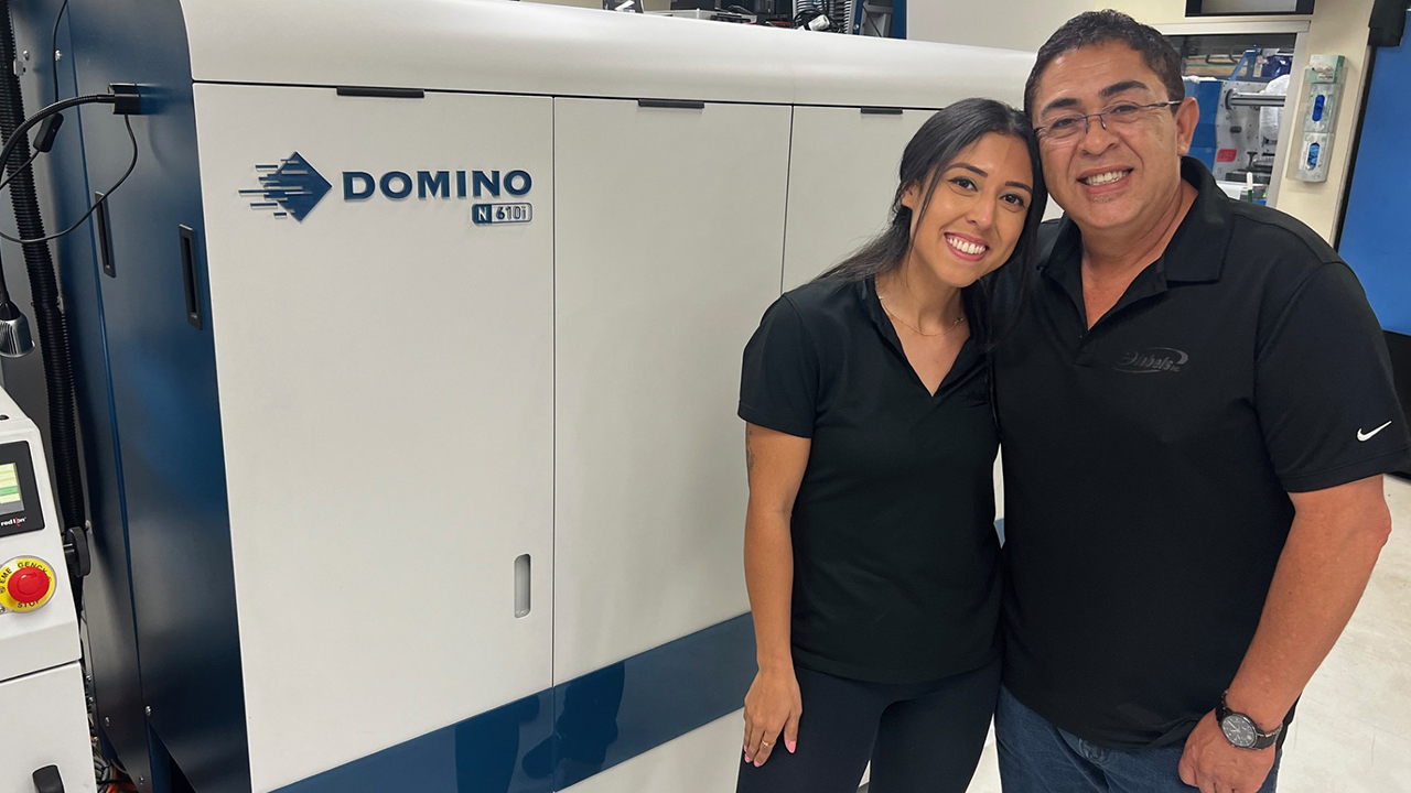 Jacky and Carlos Rivera in front of the Domino digital press