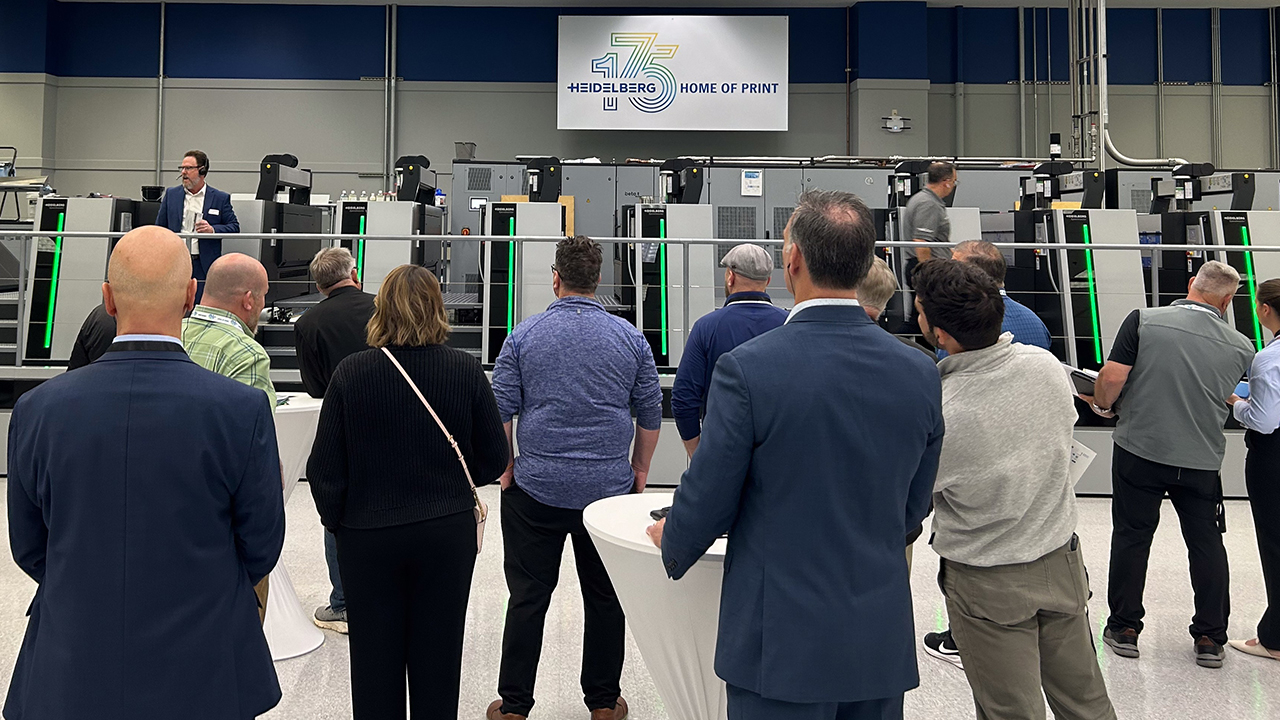 Event attendees watch a demonstration of the Speedmaster XL 106