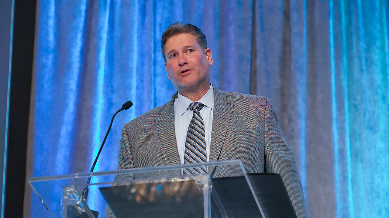 Keith Walz speaks at a podium