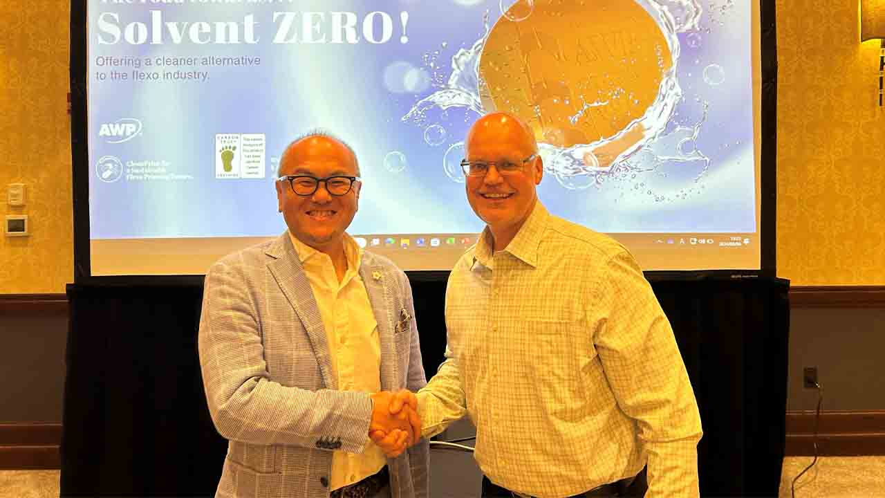 (L-R) Aki Kato, executive, senior general manager of Photoproducts Division, Asahi Photoproducts, and Jerry Collins, vice president, The Oldham Group, celebrate the first AWP Tap Water System installation.