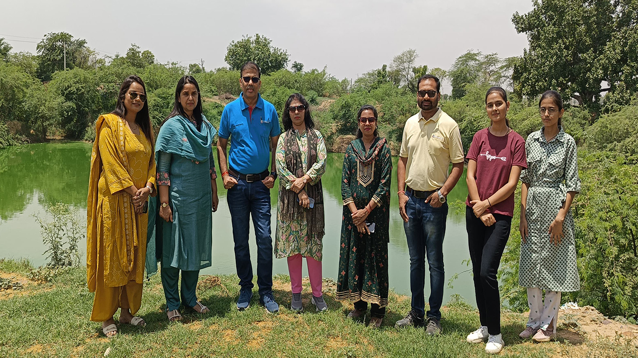 a group of Siegwerk India employees in front of a pond