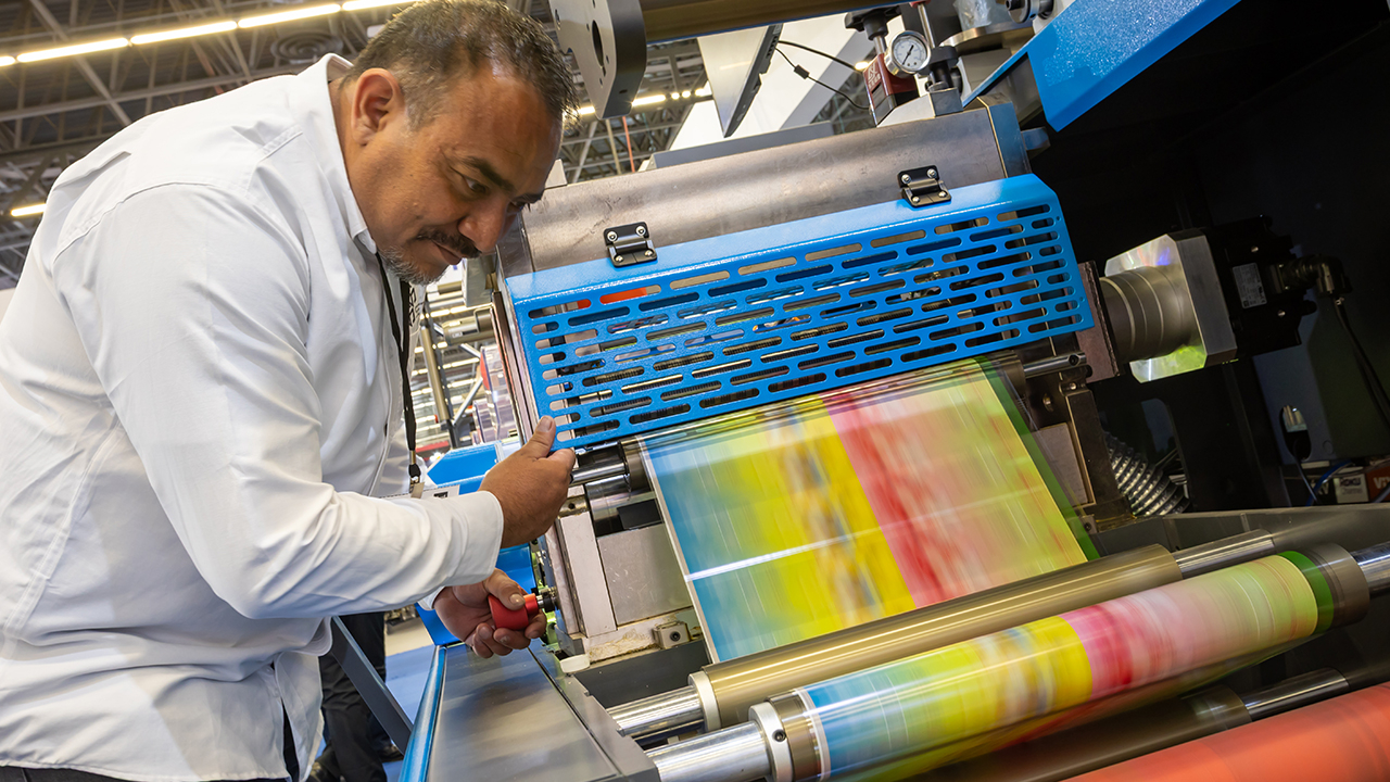 A man watches labels run through a machine