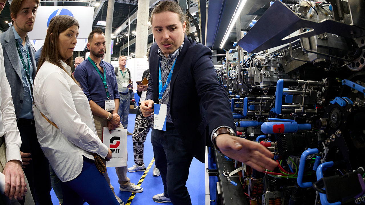 A man showcases the inside of a press
