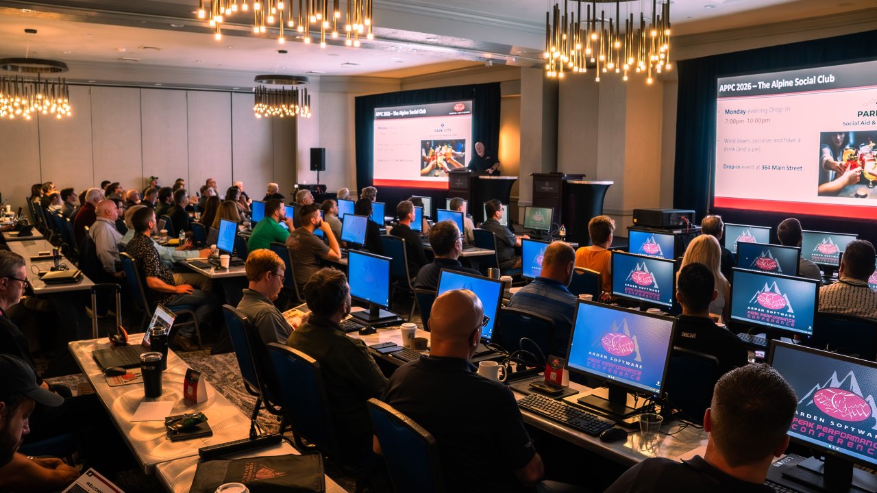 Attendees sit at desks at Arden Software user conference