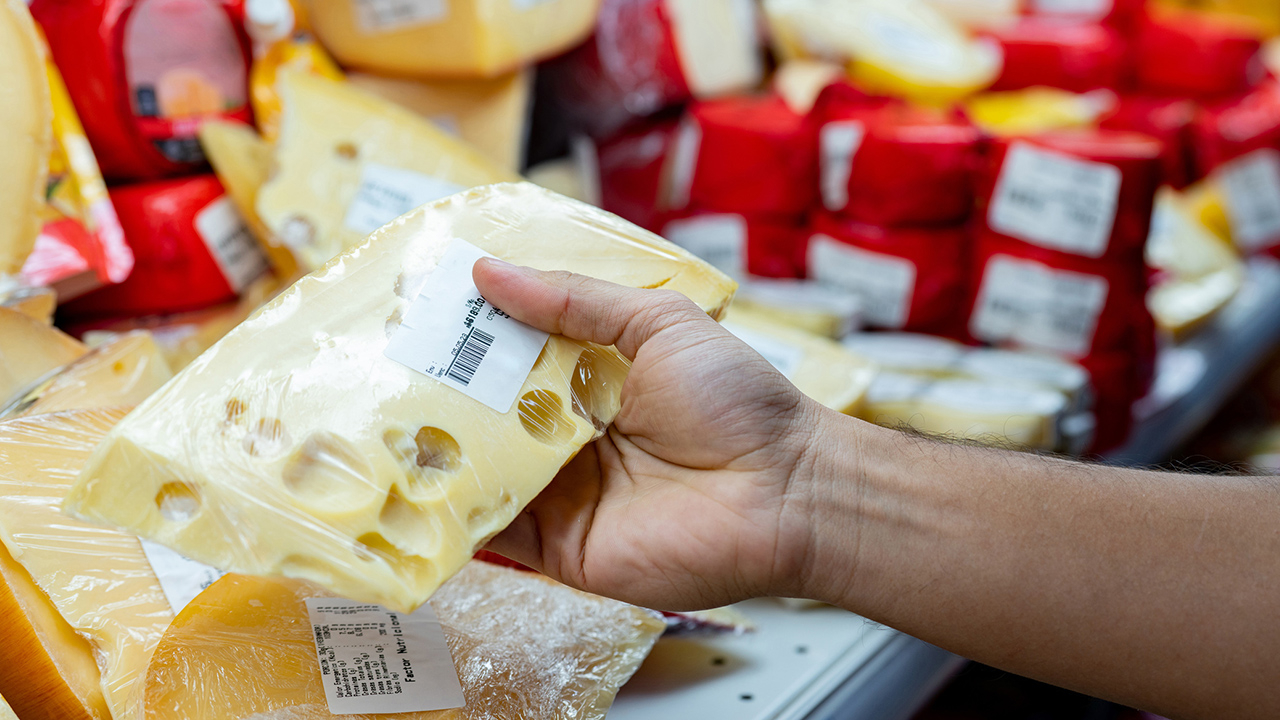 Plastic-wrapped cheese with a simple barcode label